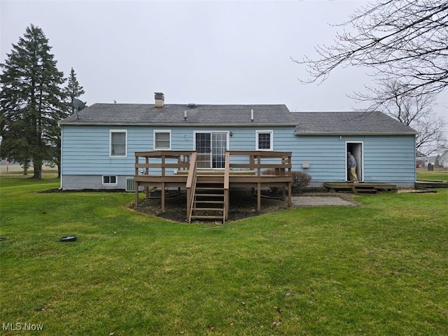 back of house with a lawn and a deck