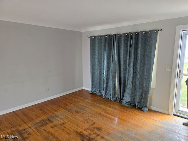 empty room with hardwood / wood-style flooring