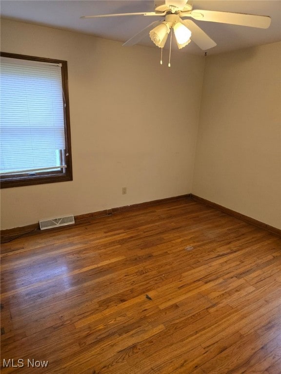 spare room featuring hardwood / wood-style floors and ceiling fan