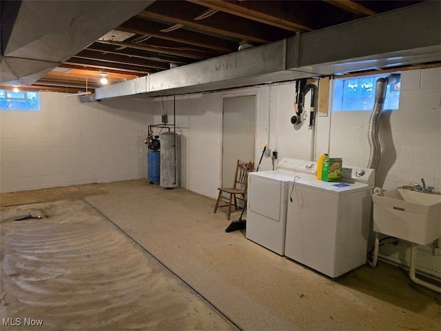 basement with washer and clothes dryer, plenty of natural light, and sink