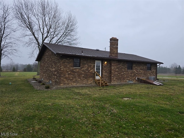 back of house with a lawn