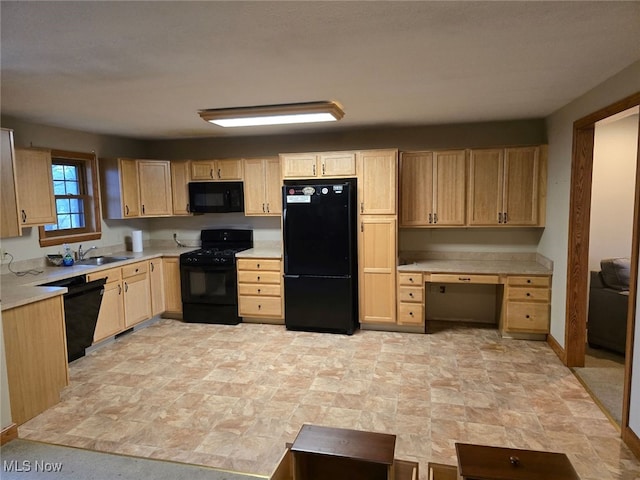 kitchen with light brown cabinets, black appliances, and sink