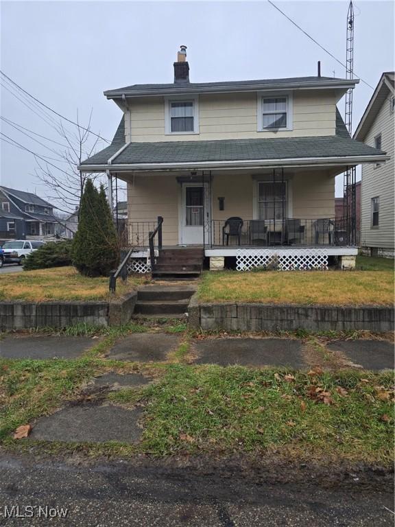 2529 17th St NE, Canton, OH 44705 - farmhouse inspired home featuring a porch and a chimney