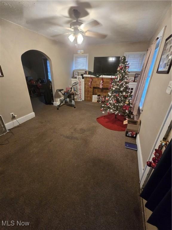 interior space featuring ceiling fan and carpet floors