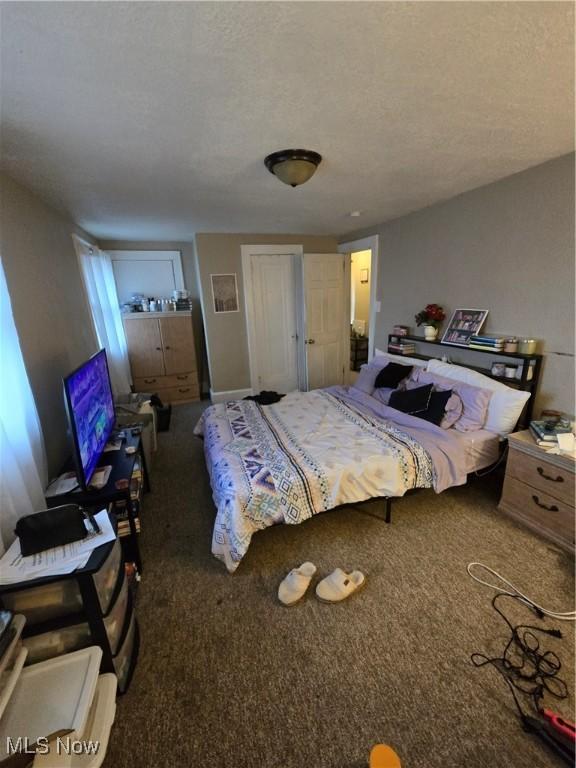 carpeted bedroom with a textured ceiling