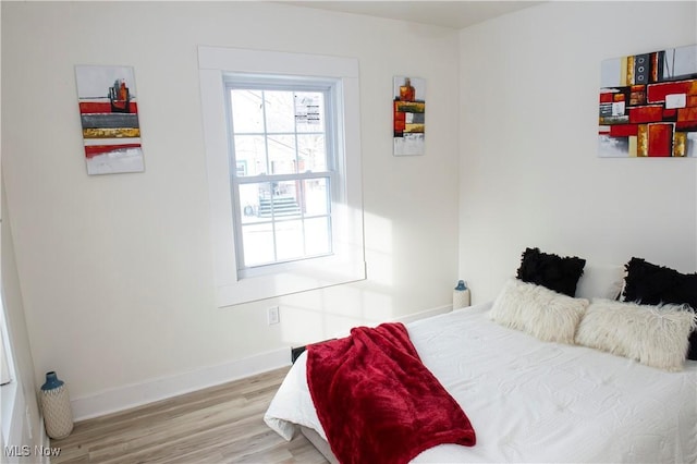 bedroom with hardwood / wood-style floors