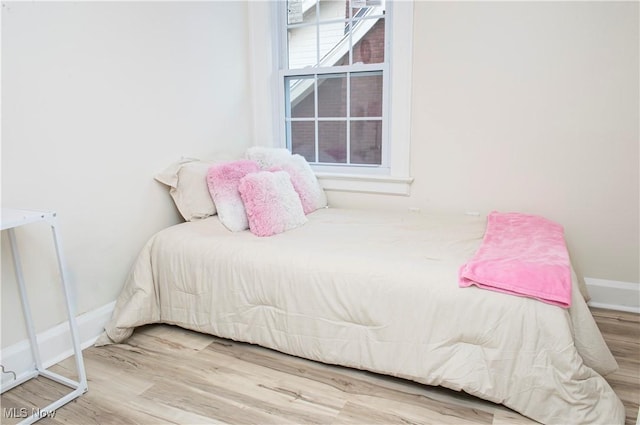 bedroom with hardwood / wood-style flooring