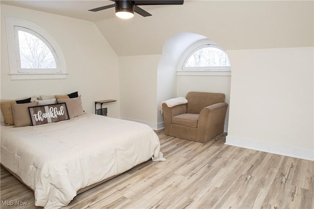 bedroom featuring ceiling fan, light hardwood / wood-style floors, and vaulted ceiling