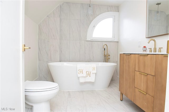 bathroom with a bathtub, toilet, lofted ceiling, and tile walls