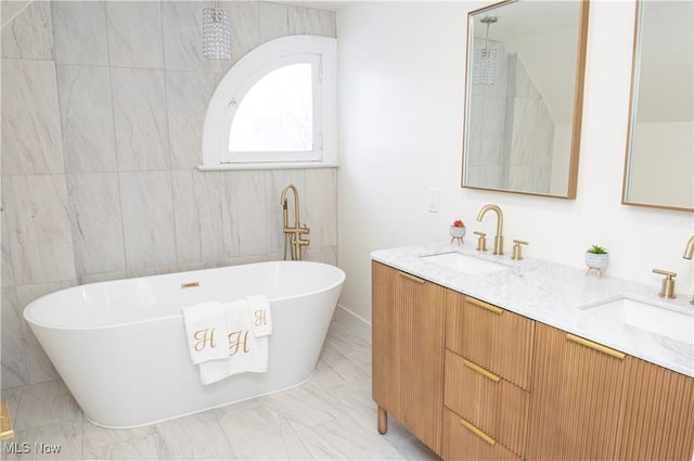 bathroom featuring vanity and a bath