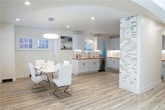 dining room featuring light hardwood / wood-style flooring and sink