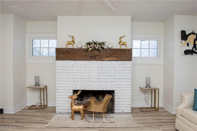 room details featuring wood-type flooring and a brick fireplace