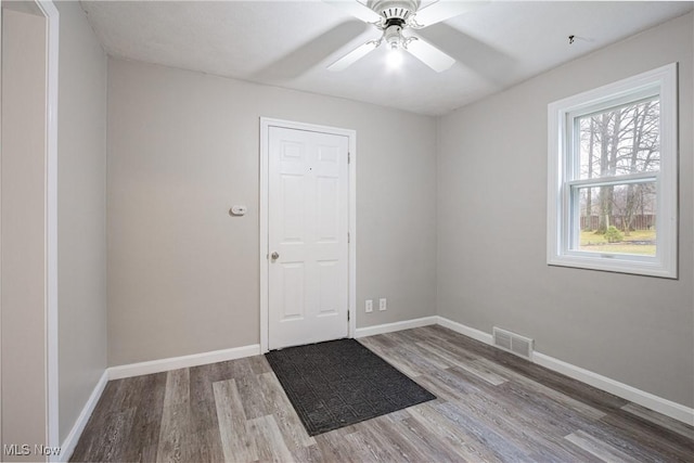 empty room featuring ceiling fan and hardwood / wood-style floors