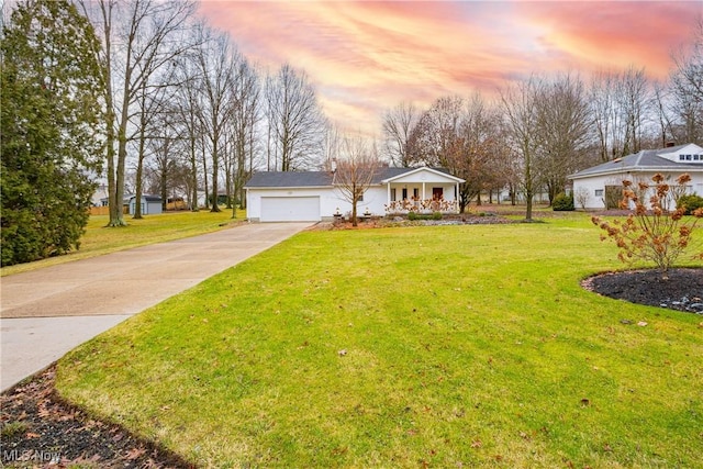 view of front facade with a yard and a garage