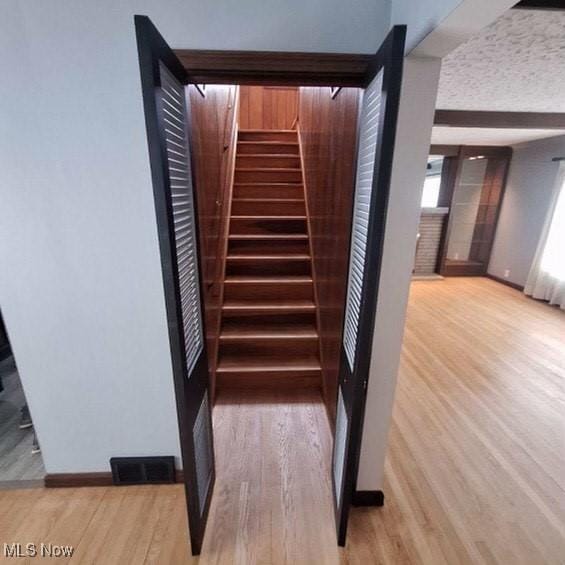 staircase featuring hardwood / wood-style floors