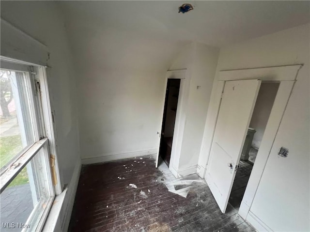 unfurnished room featuring dark wood-type flooring