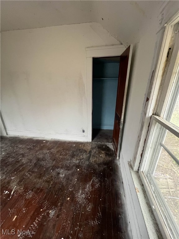 unfurnished bedroom featuring dark hardwood / wood-style floors and a closet