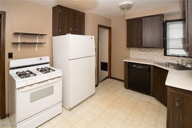 kitchen with dark brown cabinets, white appliances, and sink