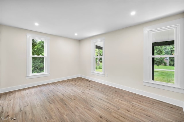 unfurnished room with light hardwood / wood-style flooring and a wealth of natural light