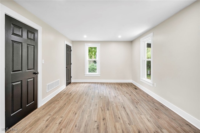 spare room with light hardwood / wood-style flooring