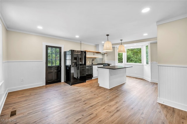 kitchen with black appliances, crown molding, hanging light fixtures, decorative backsplash, and white cabinetry