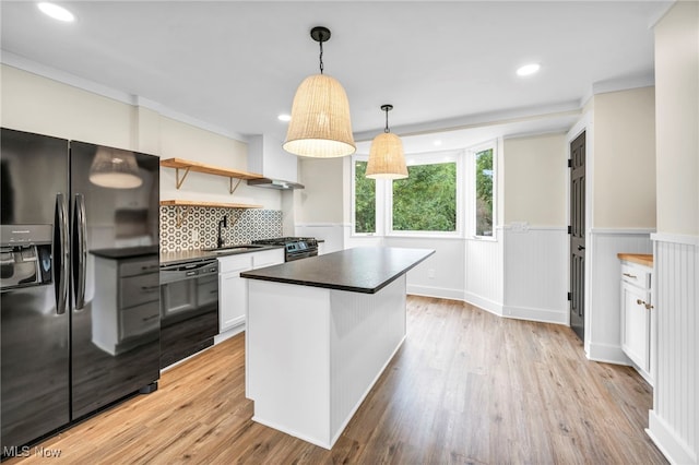 kitchen with white cabinetry, sink, light hardwood / wood-style flooring, backsplash, and black appliances