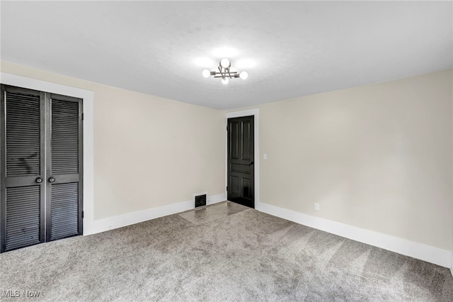 unfurnished bedroom with an inviting chandelier and a closet