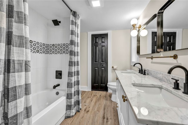 full bathroom with hardwood / wood-style floors, shower / bath combination with curtain, toilet, and vanity