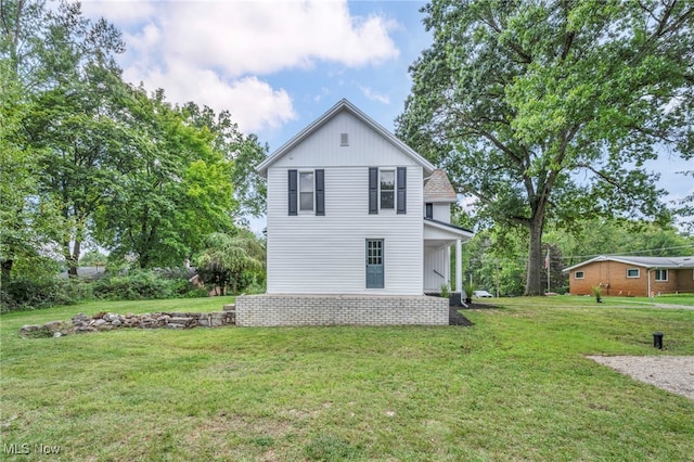 view of side of home with a lawn