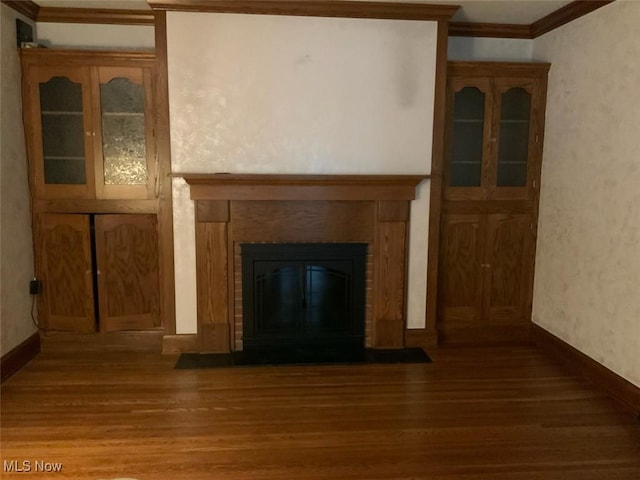 unfurnished living room with dark wood-type flooring and crown molding