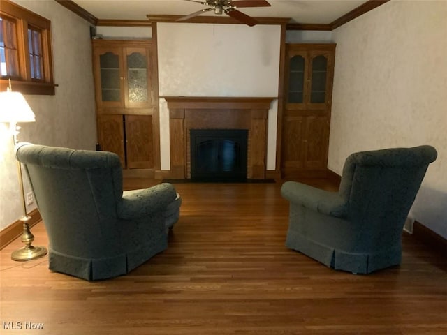 living room with ceiling fan, dark hardwood / wood-style flooring, and ornamental molding