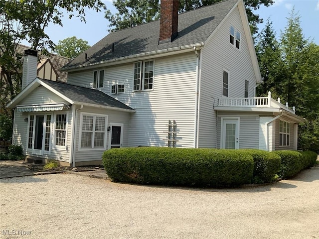 rear view of property with a balcony