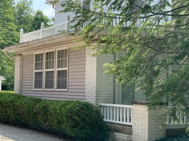 view of side of home featuring a balcony