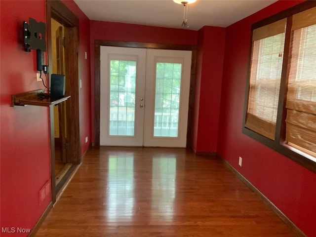 entryway with hardwood / wood-style floors and french doors