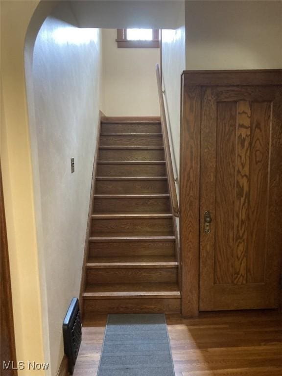 stairs featuring hardwood / wood-style floors