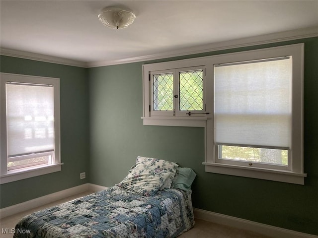 bedroom with multiple windows, carpet floors, and ornamental molding