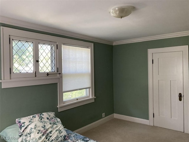 bedroom with light colored carpet, multiple windows, and crown molding