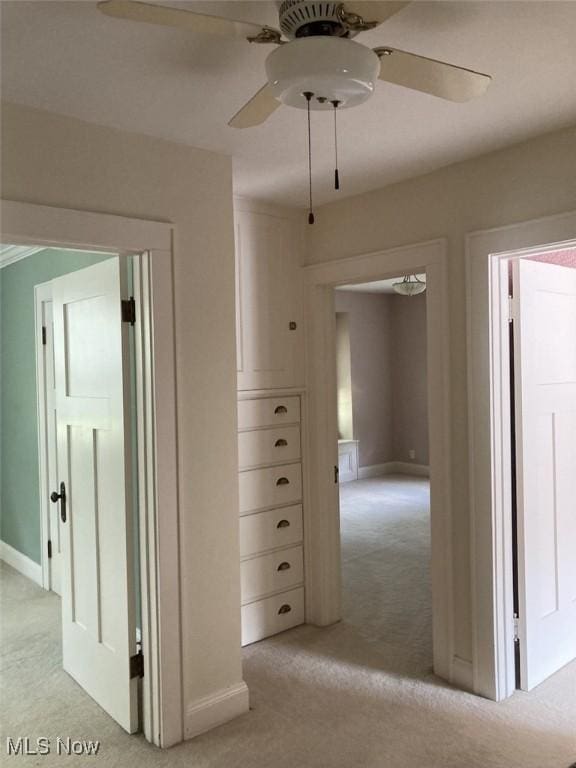 hallway with light colored carpet