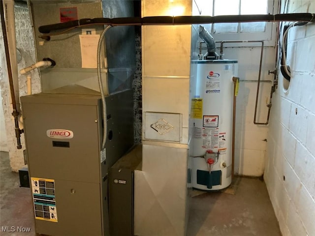 utility room featuring heating unit and gas water heater