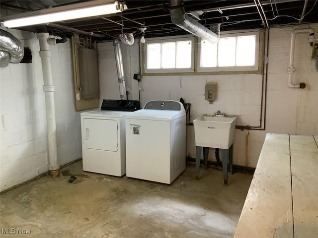 clothes washing area with electric panel and independent washer and dryer