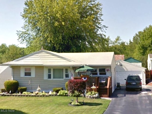 ranch-style home with a garage and a front lawn