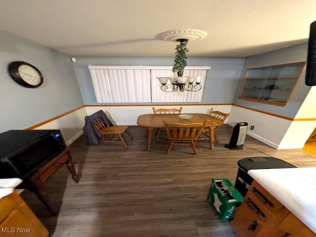 dining room featuring dark wood-type flooring and a chandelier