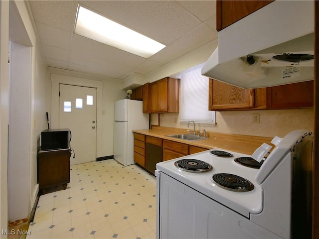 kitchen featuring white appliances, a paneled ceiling, and sink