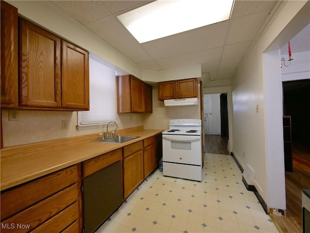 kitchen with a paneled ceiling, electric range, and sink