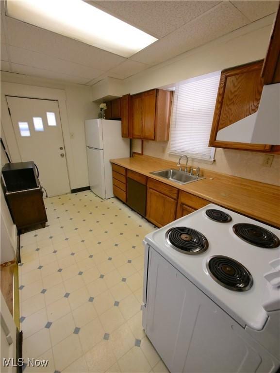 kitchen featuring white appliances and sink