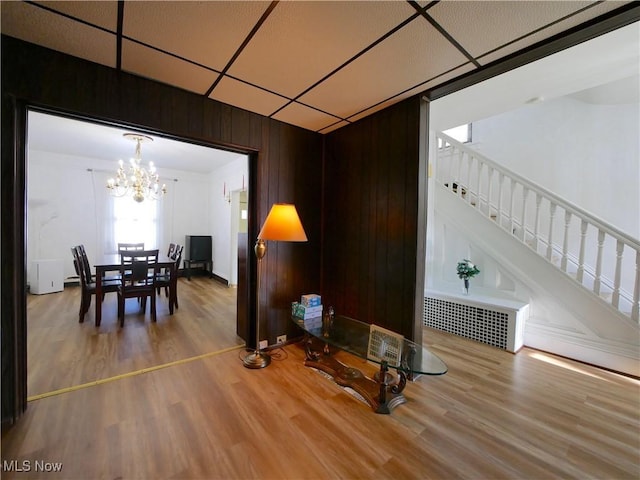 dining space featuring hardwood / wood-style flooring and an inviting chandelier