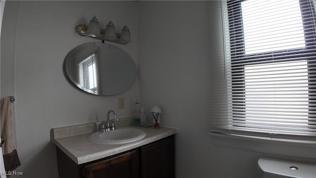 bathroom featuring vanity and toilet