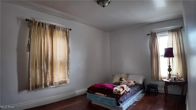 bedroom with dark hardwood / wood-style flooring