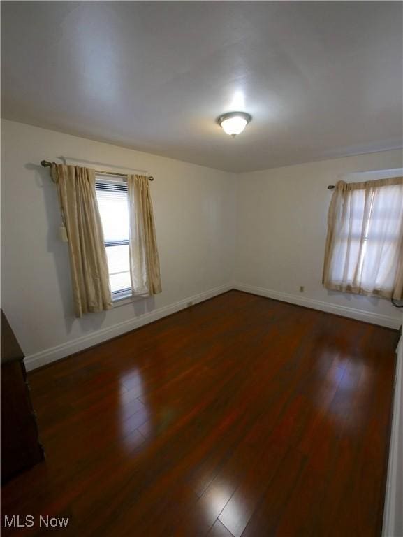 spare room with dark hardwood / wood-style floors