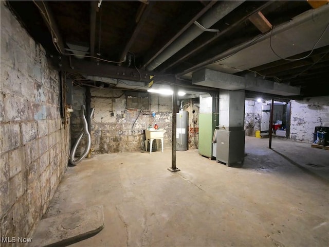 basement featuring gas water heater and heating unit